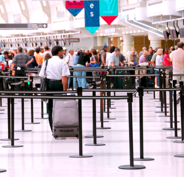 A traveler waits in line for airport security.