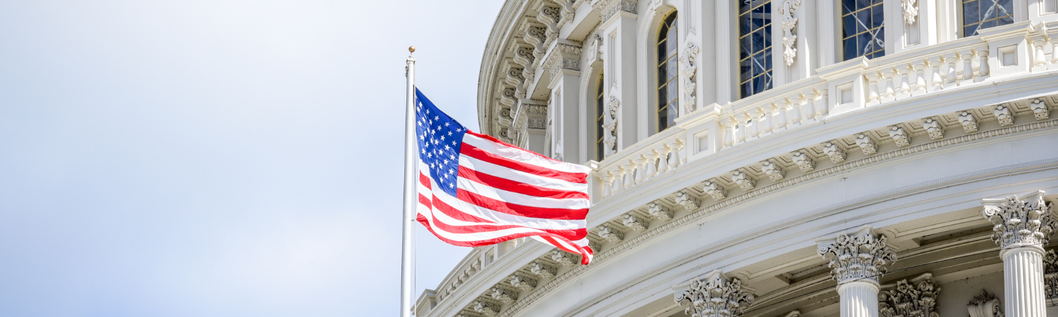 Close up of the U.S. flag and the Capitol building.