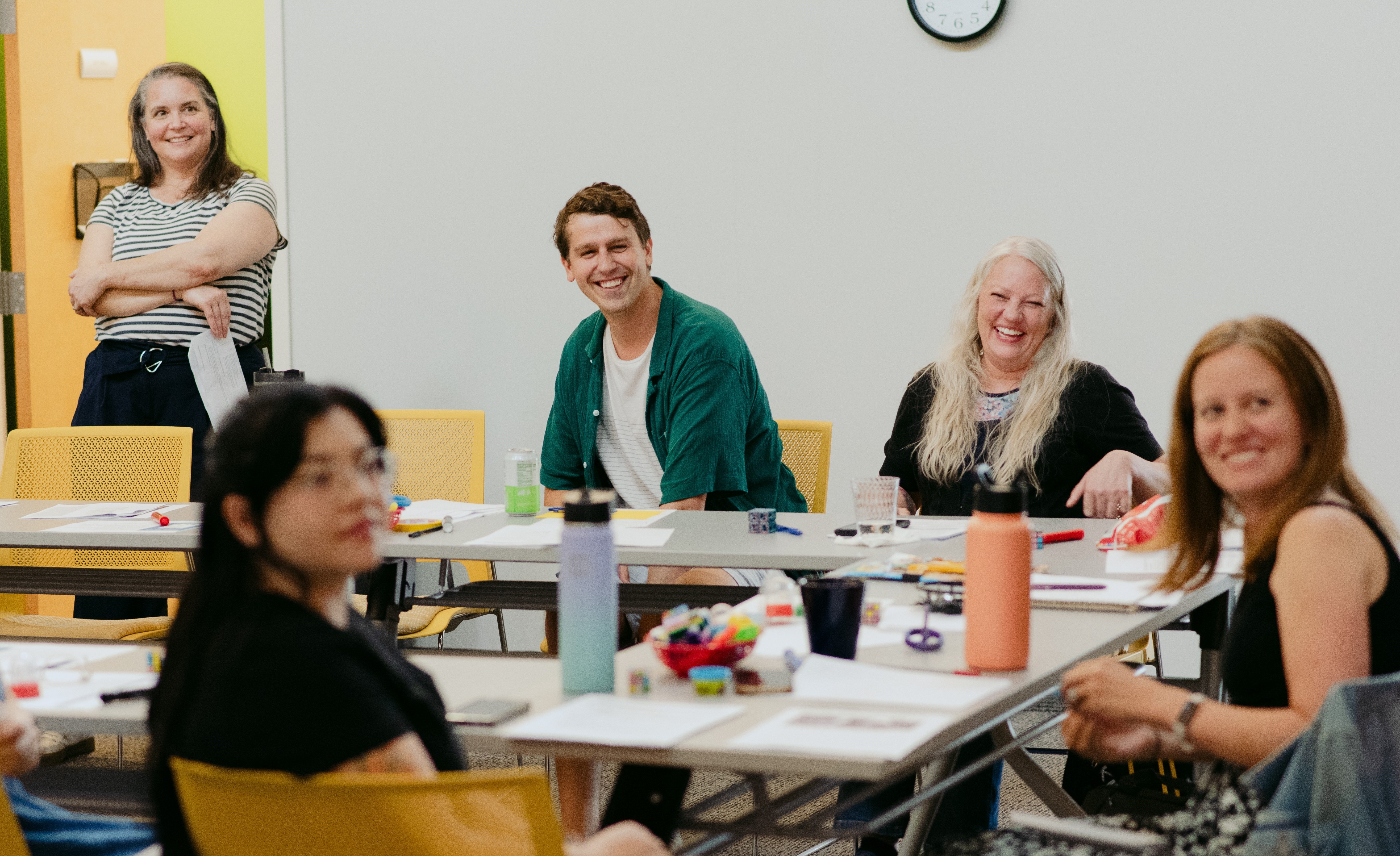 Photo of Improve Group sitting around conference table smiling.