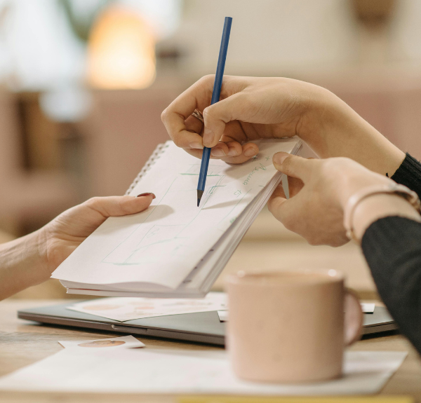 Person showing a drawing on white paper