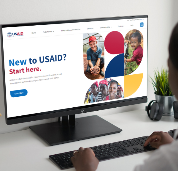 Computer with the Work-with-USAID-dot-org website on the screen